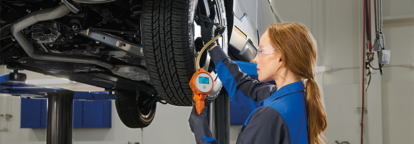 A Subaru technician checking tire pressure. | Fitzgerald Subaru Clearwater in Clearwater FL