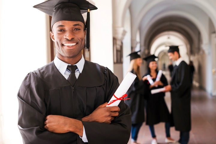 college graduate holding his diploma | Fitzgerald Subaru Clearwater in Clearwater FL